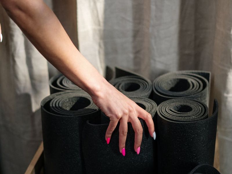 Detailed close-up of yoga mat and equipment in professional studio.